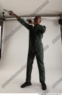 ERIC STANDING POSE WITH GUNS